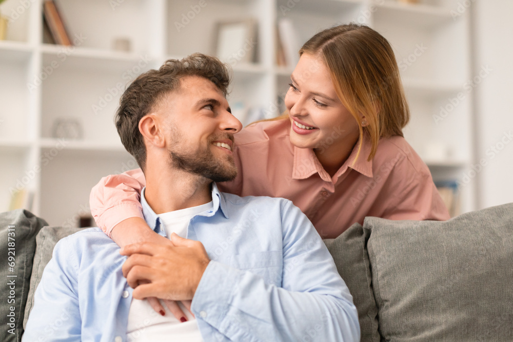 wife embraces husband smiling to him with love at home wife embraces husband smiling to him with love at home
