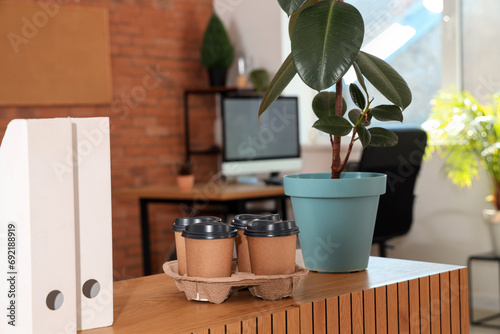 Coffee cups with plant on t...