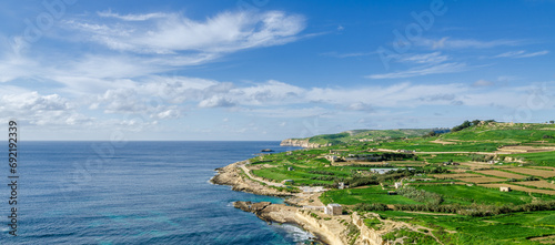 Mgarr, Malta - Panorama of Xatt l-Aħmar bay and cliffs in Malta at with beautiful colorful sky and golden rocks taken from near fort chambray