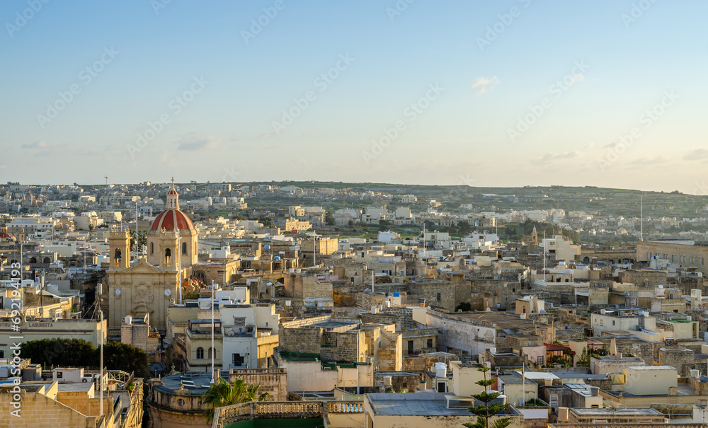 Fortified buildings and the old moat within the citadel with views towards the city and Church, Victoria, Gozo, Malta, Europe, January 11, 2022.