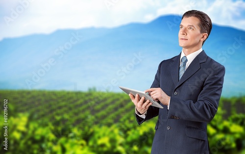 Young agronomist with digital tablet at the field