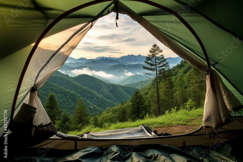 Traveler green tent Camping outdoor travel. View from the tent inside on the blue sky and mountain landscape. during the evening of the day suitable for sleeping and resting the body