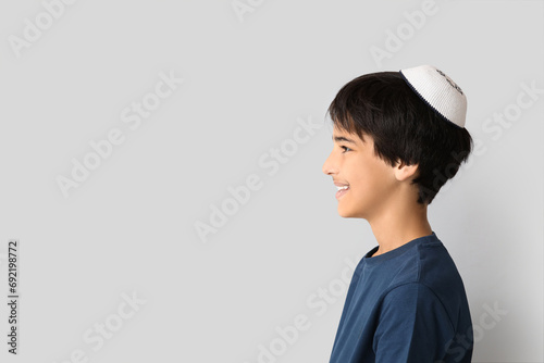 Little Israeli boy in kipa on grey background photo