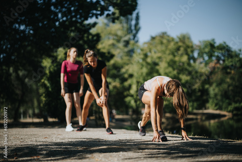 Fit girls in a city park, stretching and warming up their bodies in a positive atmosphere.