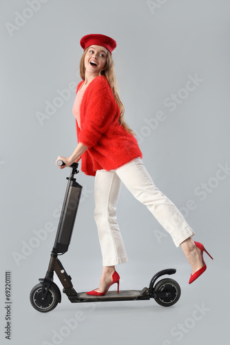 Stylish young woman riding ...