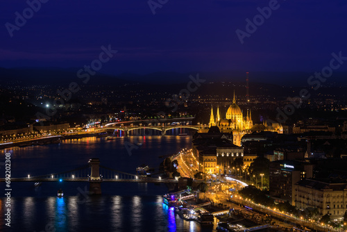 Picturesque evening Budapest cityscape at blue hour with illuminated Chain Bridge and Hungarian Parliament on Danube River.