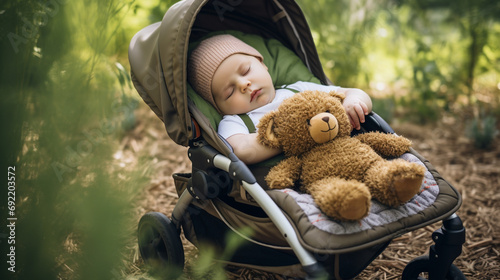 Cute European baby girl peacefully sleeping in a stroller with her stuffed toy outdoors surrounded by greenery, photography  photo