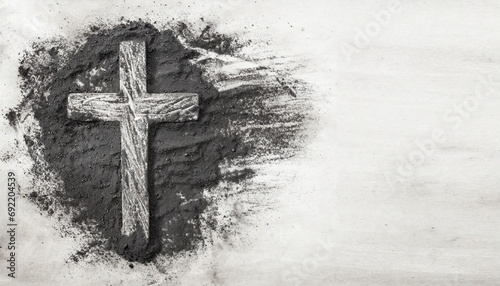 Christian cross drawing in ash as symbol of religion. Sacrifice, Jesus Christ, Ash Wednesday concept photo