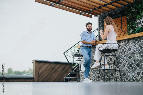 A business couple in the city center discusses new ideas and expansion plans outdoors on a cloudy day. Efficient communication and planning for profit growth show their success as young investors.