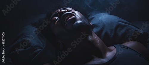 Anxious black man seeing bad dreams during sleeping suffering from nightmares. Copy space image. Place for adding text or design