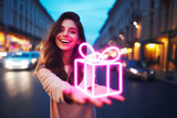 happy girl holds out a neon glowing gift against the backdrop of a city street.