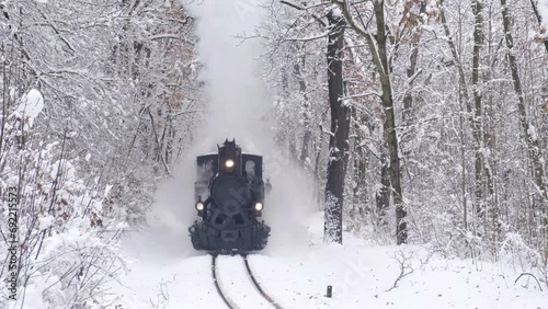 Steam train wheels close-up view in winter forest