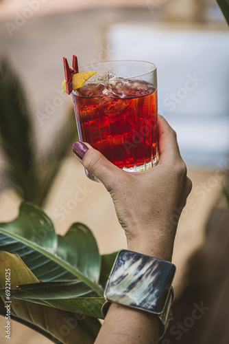 woman drinking fruity cocktail in the afternoon