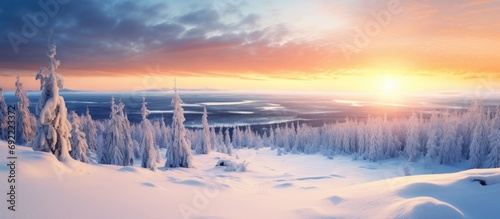 Aerial view to winter landscape in Lapland Finland Snow covered fir trees at sunset. Copy space image. Place for adding text or design photo