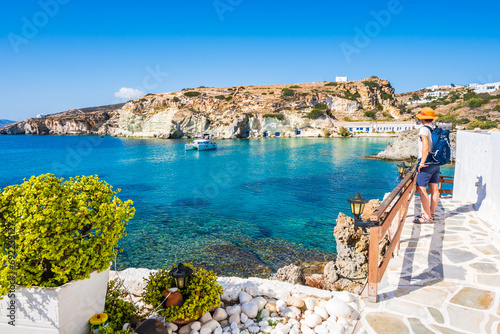 Young woman tourist looking at Rema beach in beautiful sea bay  Kimolos island  Cyclades  Greece