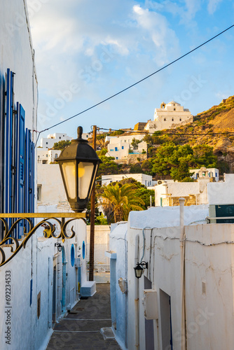 Fototapeta Naklejka Na Ścianę i Meble -  Narrow streets of Plaka village with traditional white houses at sunset time, Milos island, Cyclades, Greece