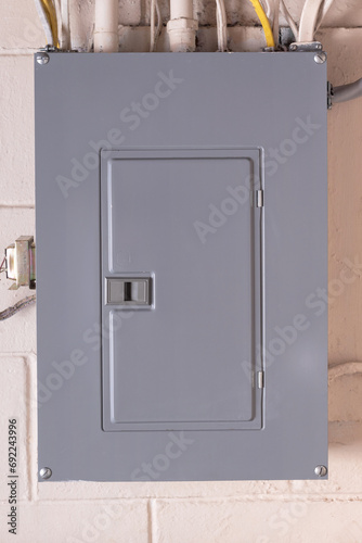 Circuit breaker box in the basement. Electrical service panel mounted on the wall.