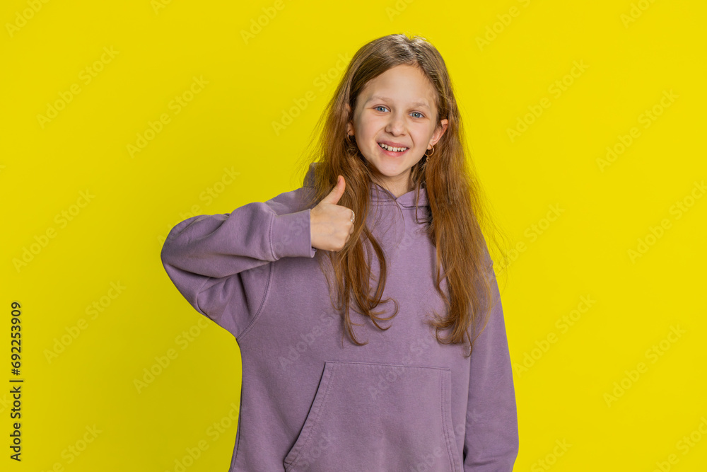 Like. Happy young preteen child girl kid looking approvingly at camera showing thumbs up, like sign positive something good, positive feedback great news. Children isolated on studio yellow background Like. Happy young preteen child girl kid looking approvingly at camera showing thumbs up, like sign positive something good, positive feedback great news. Children isolated on studio yellow background