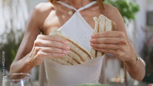Woman hands holding pita dinning lebanese restaurant closeup. Lady eating bread photo