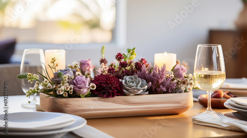 centerpiece made of flowers, with candles and wine glasses, decoration for events photo