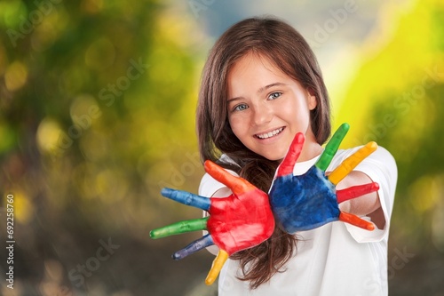 Happy  cute little girl with hands in paint