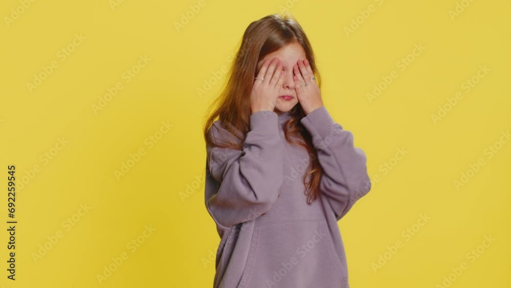 Don't want to look at this, awful. Afraid shocked preteen child girl kid closing eyes with hand showing stop gesture, confused shy scared reject to watch. Teen children isolated on yellow background Don't want to look at this, awful. Afraid shocked preteen child girl kid closing eyes with hand showing stop gesture, confused shy scared reject to watch. Teen children isolated on yellow background