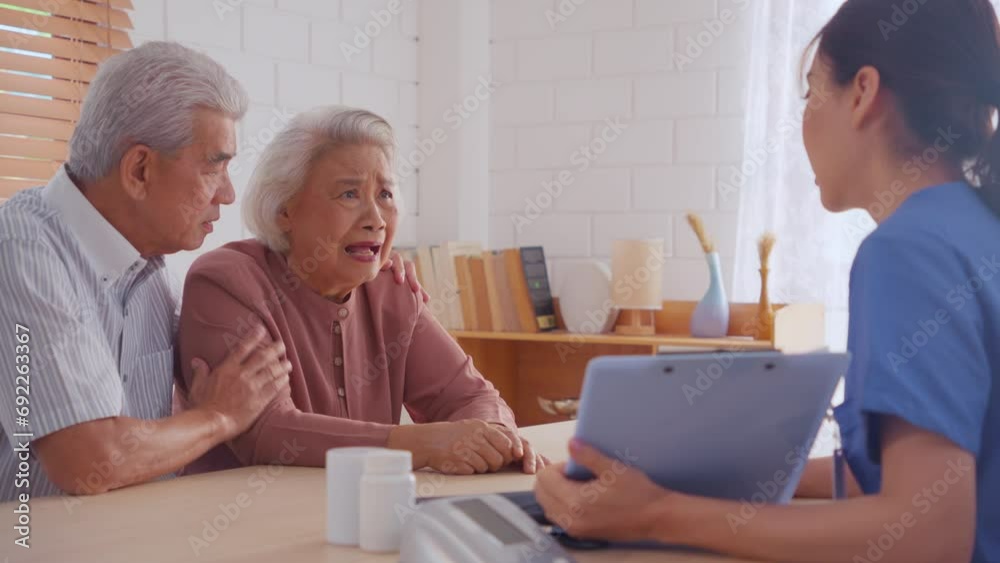 Asian caregiver examine depress senior crying woman patient and husband. Asian caregiver examine depress senior crying woman patient and husband.
