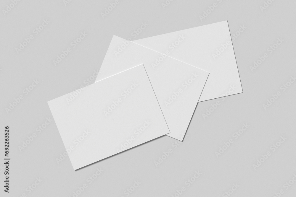 Top view of paper mockup on gray background. Can be a brochure, flyer, poster, planner, and so on Top view of paper mockup on gray background. Can be a brochure, flyer, poster, planner, and so on