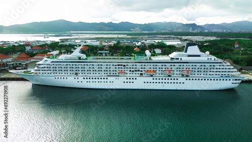 Photography Aerial view of a huge cruise ship waiting to depart at a port on a tropical island