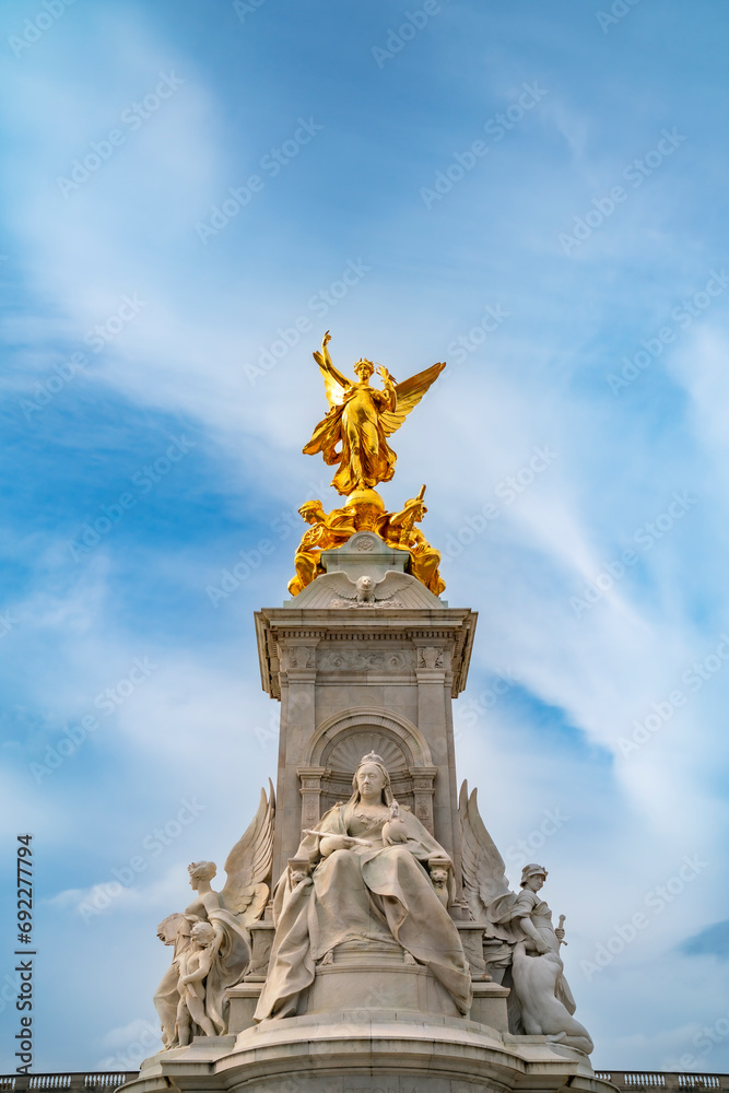 Fototapeta premium From below of Queen Victoria Memorial monument located at the end of The Mall in front of The Buckingham Palace under cloudy blue sky in Westminster, London