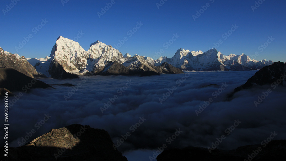 Mountain ranges of the Himalayas and sea of fog. View from Gokyo Peak, Nepal.