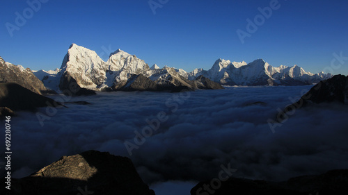 Mountain ranges of the Himalayas and sea of fog. View from Gokyo Peak, Nepal. photo