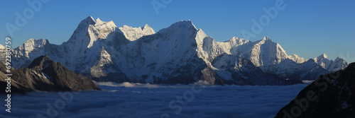 Sun lit mountains Kantega, Thamserku and Kusum Kanguru, Nepal photo