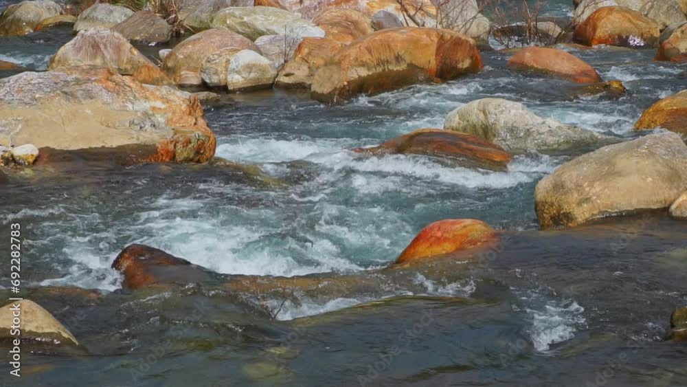 Slow motion of water flowing between rocks in a stream with the sound of running water. Slow motion of water flowing between rocks in a stream with the sound of running water.