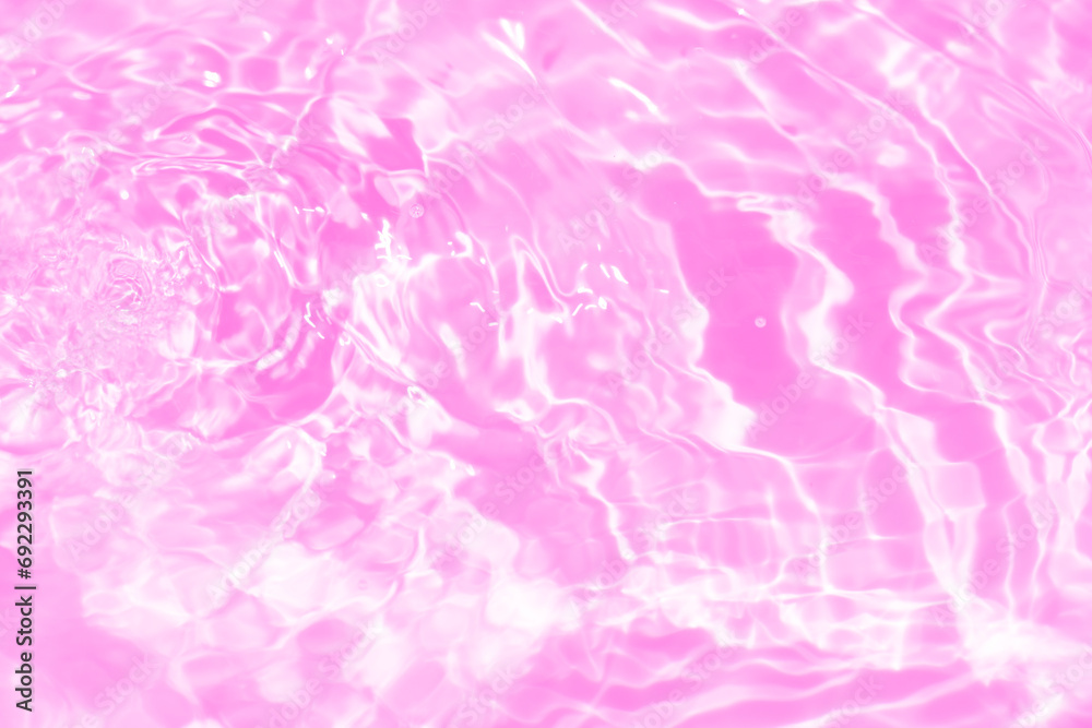 Fototapeta premium Pink water bubbles on the surface ripples. Defocus blurred transparent purple colored clear calm water surface texture with splash and bubbles. Water waves with shining pattern texture background