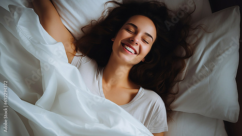 Image of a young woman sleeping comfortably on comfortable bedding.
