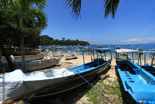 Padangbai in Bali, Indonesia with fishing boats in the sea photo