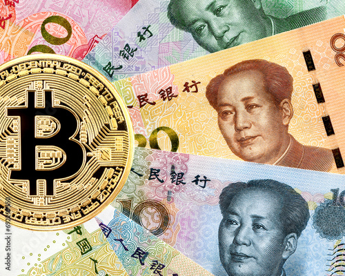 Bitcoin cryptocurrency and banknotes of Chinese money with portrait of Mao Zedong