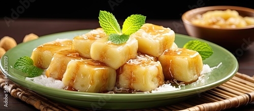 Es Pisang Ijo is a traditional Indonesian dessert made with rolled banana and a mixture of wheat flour, rice flour, and coconut milk, served with pureed fruit and syrup.