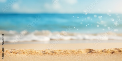 Golden sand meets the tranquil blue sea, creating a summery beach backdrop with sunlights shimmering and creating a defocused effect photo
