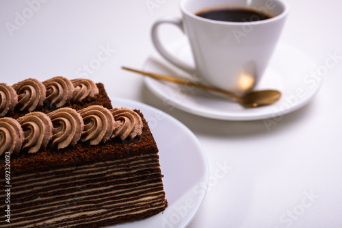 chocolate cream cake with tea, coffee with a piece of spartak, on a light background. photo