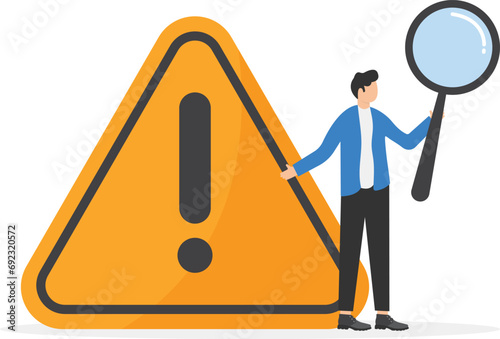Businessman with magnifying monitor and investigate incident with exclamation attention sign. Incident management, root cause analysis or solving problem, identify risk or critical failure concept.

