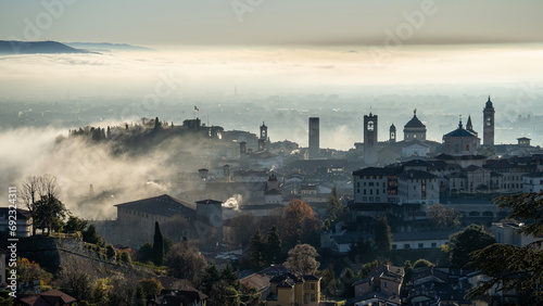 Bergamo, one of the most beautiful city in Italy. Amazing aerial landscape of the fog rises from the plains and covers the old town