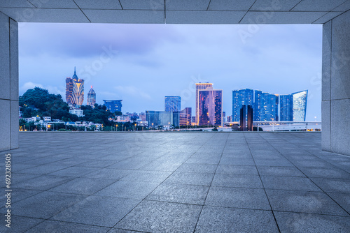 Empty square floor and Macau city skyline at dusk