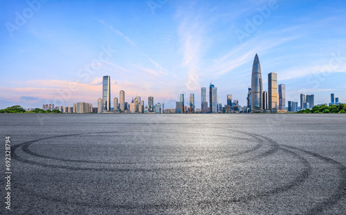 Asphalt road and urban skyline with modern buildings at sunrise in Shenzhen  Guangdong Province  China.