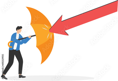 Businessman holding umbrella to cover and protect from downturn arrow. Protection or defensive stock in economy crisis or market crash, business resilient to survive difficulty or insurance concept.

