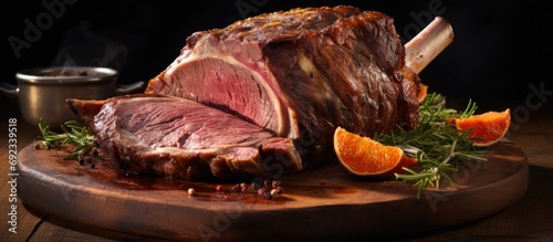 Close-up of a fresh organic prime rib on a brown cutting board, with marbled juicy raw meat and rib bones, in a restaurant. photo
