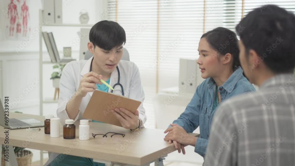 Young asian doctor describing the checking up result to a senior patient in hospital, medical concept. Young asian doctor describing the checking up result to a senior patient in hospital, medical concept.