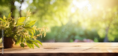 Capturing nature palette. Inviting wooden table bathed in radiant light of spring and summer. Greenery of the garden surrounds empty table creating perfect blend of natural harmony photo