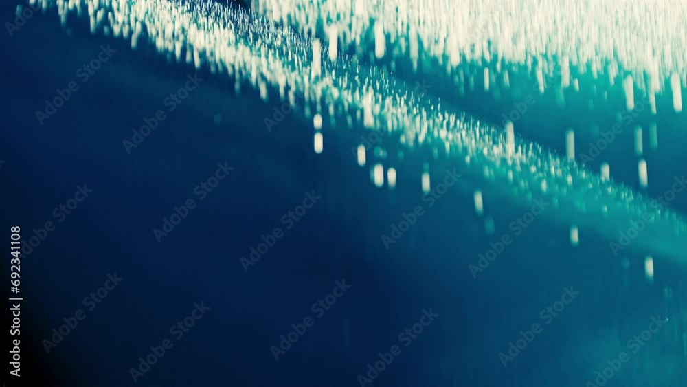 Abstract dark background with blue cold flashing light beam spot and laser illuminate falling rain and smoke. Sharp laser beams and narrow light streaks flashing rapidly.